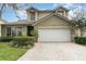 Two-story house with a landscaped lawn, driveway and attached garage at 1716 Harris Hawk Rd, Orlando, FL 32837