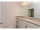 Double vanity bathroom with granite countertop and large mirror at 14421 Shaman Way, Winter Garden, FL 34787