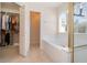 Clean bathroom with a bathtub, shower, and walk-in closet at 15543 Pebble Ridge St, Winter Garden, FL 34787