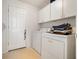 Bright laundry room with washer, dryer, and cabinets at 15543 Pebble Ridge St, Winter Garden, FL 34787