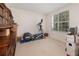 Bright home gym with elliptical machine, window, and hardwood floors at 15543 Pebble Ridge St, Winter Garden, FL 34787