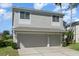 Two-story house with neutral siding, two-car garage, and landscaping at 15543 Pebble Ridge St, Winter Garden, FL 34787