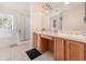 Elegant bathroom with a double vanity and a large shower at 15543 Pebble Ridge St, Winter Garden, FL 34787