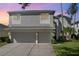 Two-story house with a two-car garage and landscaped lawn at 15543 Pebble Ridge St, Winter Garden, FL 34787