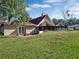 Back exterior view, showcasing the home's red roofline and patio at 500 Teacup Springs Ct, Winter Garden, FL 34787