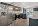 Modern kitchen with stainless steel appliances and dark green cabinetry at 500 Teacup Springs Ct, Winter Garden, FL 34787