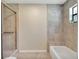 Clean bathroom with shower/tub combo and updated tile at 500 Teacup Springs Ct, Winter Garden, FL 34787