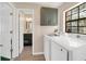 Bright laundry room with washer, dryer, and access to a small bathroom at 500 Teacup Springs Ct, Winter Garden, FL 34787