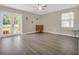 Bright living room featuring hardwood floors and sliding glass doors at 500 Teacup Springs Ct, Winter Garden, FL 34787