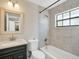 Clean bathroom with shower/tub combo and updated tile at 500 Teacup Springs Ct, Winter Garden, FL 34787