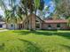 Brick ranch home with red roof and lush lawn at 500 Teacup Springs Ct, Winter Garden, FL 34787