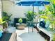 Outdoor patio with seating area, umbrella, and lush greenery at 10301 Us Highway 27 # 85, Clermont, FL 34711