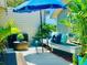 Private patio with seating area, umbrella, and tropical plants at 10301 Us Highway 27 # 85, Clermont, FL 34711