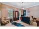 Spacious bedroom with a wooden bed, chair and alligator skin rug at 2228 Azalea Pl, Winter Park, FL 32789