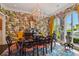 Formal dining room with a patterned wallpaper, chandelier, and large windows at 2228 Azalea Pl, Winter Park, FL 32789