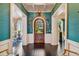 Bright entryway with a wooden door and eclectic wall decor at 2228 Azalea Pl, Winter Park, FL 32789
