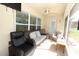 Relaxing screened porch with comfortable seating and ceiling fan at 1545 Blue Sky Blvd, Haines City, FL 33844