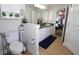 Bathroom with double vanity, toilet and a view into the bedroom at 1545 Blue Sky Blvd, Haines City, FL 33844