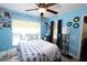 Light blue bedroom with a double bed, ceiling fan and plenty of storage at 1545 Blue Sky Blvd, Haines City, FL 33844