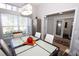 Dining room with glass table, modern chandelier, and views to kitchen and entry at 1545 Blue Sky Blvd, Haines City, FL 33844