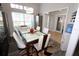 Bright dining room with a large table, hardwood floors, and access to kitchen at 1545 Blue Sky Blvd, Haines City, FL 33844