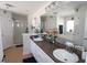 Bathroom with double vanity and a view of the garden tub and shower at 1545 Blue Sky Blvd, Haines City, FL 33844