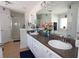 Bathroom with double vanity and a view of the garden tub and shower at 1545 Blue Sky Blvd, Haines City, FL 33844