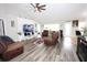 Bright living room featuring hardwood floors and ample seating at 1545 Blue Sky Blvd, Haines City, FL 33844