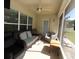 Relaxing screened porch with seating and ceiling fan at 1545 Blue Sky Blvd, Haines City, FL 33844