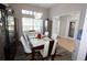 Bright dining room with a large table, hardwood floors, and access to kitchen at 1545 Blue Sky Blvd, Haines City, FL 33844