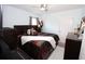 Bedroom with a king-size bed, dark wood furniture, and ceiling fan at 1545 Blue Sky Blvd, Haines City, FL 33844