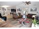 Open living room with hardwood floors, ceiling fan, and views into the kitchen at 1545 Blue Sky Blvd, Haines City, FL 33844