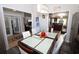 Bright dining room with a large table, hardwood floors, and access to kitchen at 1545 Blue Sky Blvd, Haines City, FL 33844