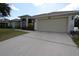 Single-story home with a two-car garage and well-maintained landscaping at 1545 Blue Sky Blvd, Haines City, FL 33844