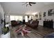 Open living area with hardwood floors, large windows and comfortable seating at 1545 Blue Sky Blvd, Haines City, FL 33844