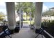 Bright screened porch with open door and view of the yard at 1545 Blue Sky Blvd, Haines City, FL 33844