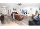 Spacious living room with wood-look floors and comfortable reclining furniture at 1545 Blue Sky Blvd, Haines City, FL 33844