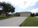 Single-story home with a two-car garage and a spacious driveway at 1545 Blue Sky Blvd, Haines City, FL 33844