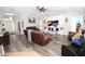 Spacious living room with wood-look floors and comfortable reclining furniture at 1545 Blue Sky Blvd, Haines City, FL 33844