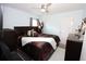 Bedroom with a king-size bed, dark wood furniture, and ceiling fan at 1545 Blue Sky Blvd, Haines City, FL 33844