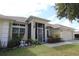 Single-story home with a screened porch, well-manicured lawn, and a two-car garage at 1545 Blue Sky Blvd, Haines City, FL 33844