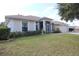 One-story house with a landscaped yard, screened porch, and attached garage at 1545 Blue Sky Blvd, Haines City, FL 33844