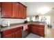 Kitchen with wood cabinets, granite countertops, and stainless steel appliances at 1545 Blue Sky Blvd, Haines City, FL 33844