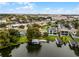 Wide aerial view of a waterfront home with a large backyard and boat dock at 632 Country Club Dr, Winter Park, FL 32789