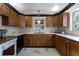 Kitchen with wood cabinets, double sink, and tile flooring at 632 Country Club Dr, Winter Park, FL 32789