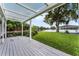Lakefront backyard with a pergola, deck, and lush landscaping at 632 Country Club Dr, Winter Park, FL 32789