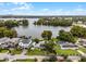 Wide aerial view of a waterfront home on a lake with a city skyline in the distance at 632 Country Club Dr, Winter Park, FL 32789