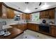 Cozy kitchen featuring wood cabinets, and a built-in oven at 632 Country Club Dr, Winter Park, FL 32789