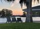 Relaxing view of the lake and lush landscaping from comfortable lounge chairs at 632 Country Club Dr, Winter Park, FL 32789