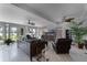 Living room with leather furniture and large windows overlooking the backyard at 632 Country Club Dr, Winter Park, FL 32789